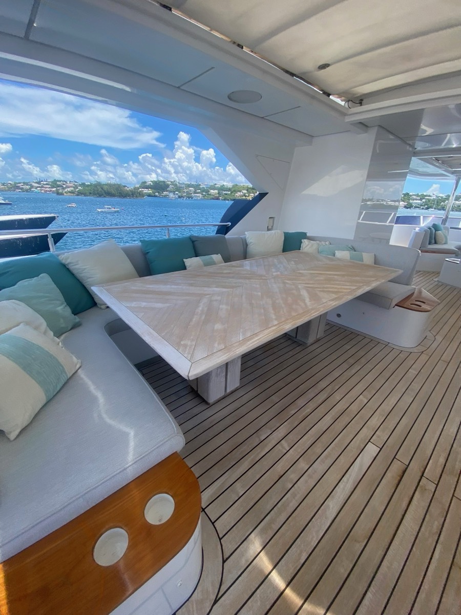 Majesty 142 aft deck lounging and dining seating after an upholstery refit