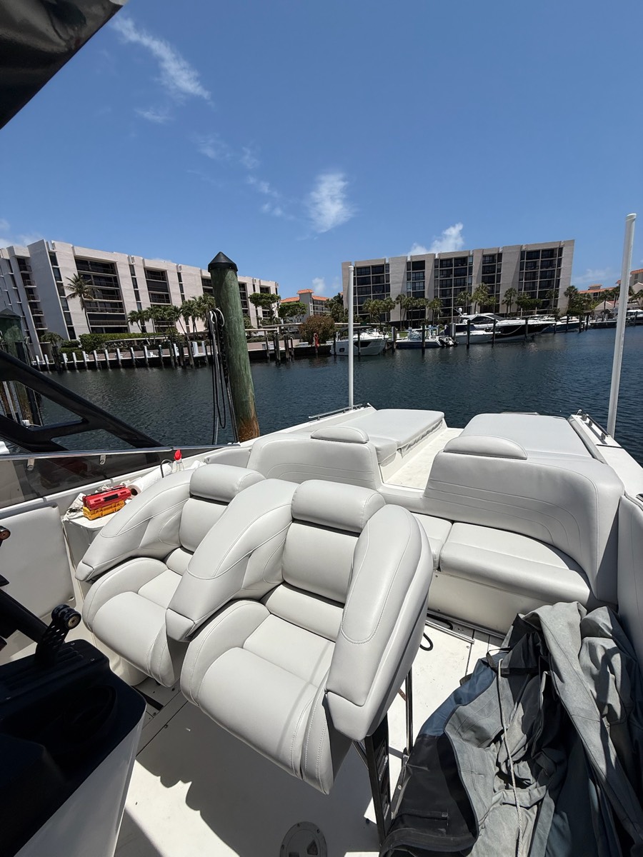 Custom speed boat bow seating and filler cushions rebuilt in marine upholstery