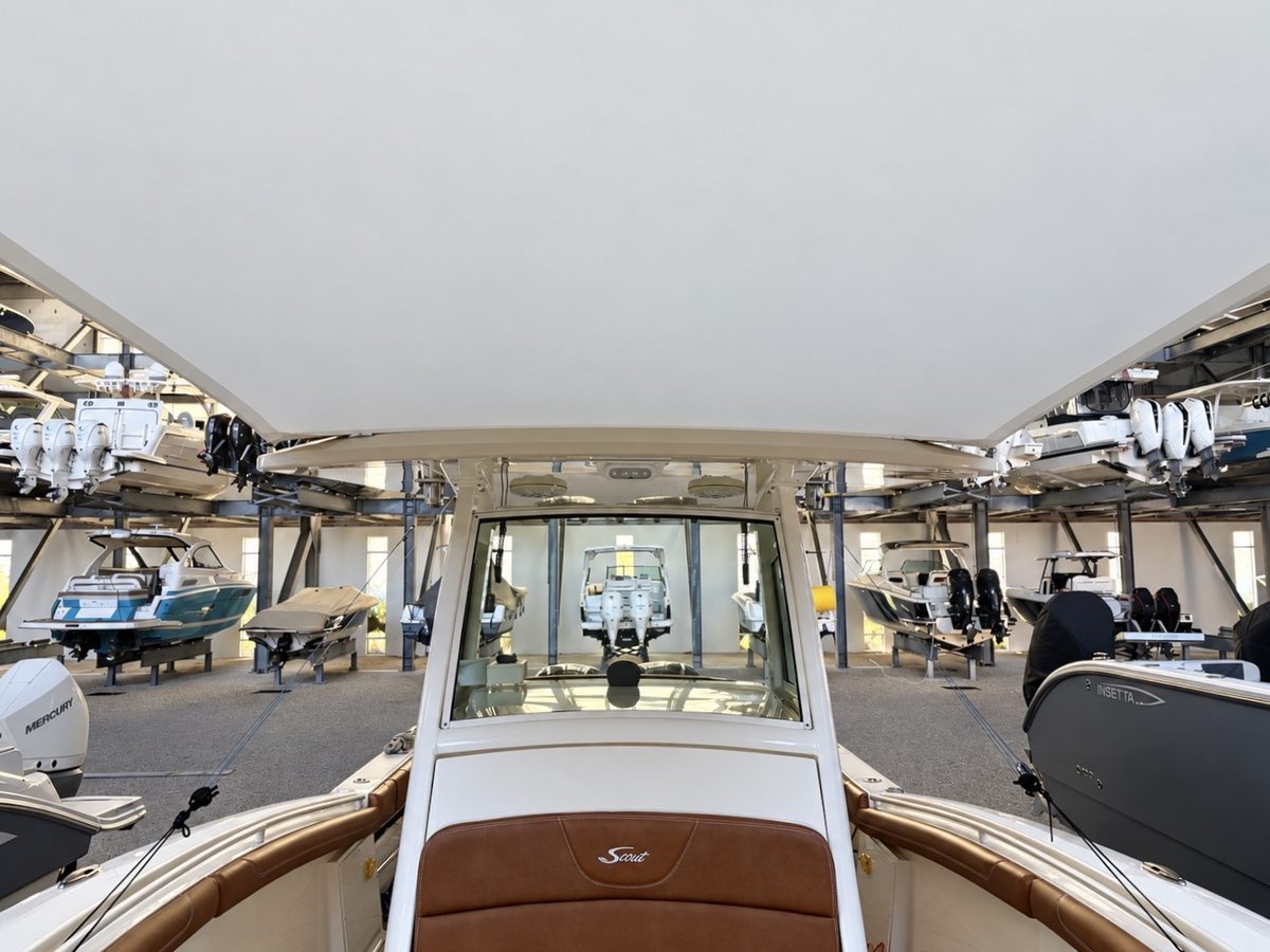 View from the helm of a 32-foot Scout center console looking forward, shaded by a custom bow sun shade