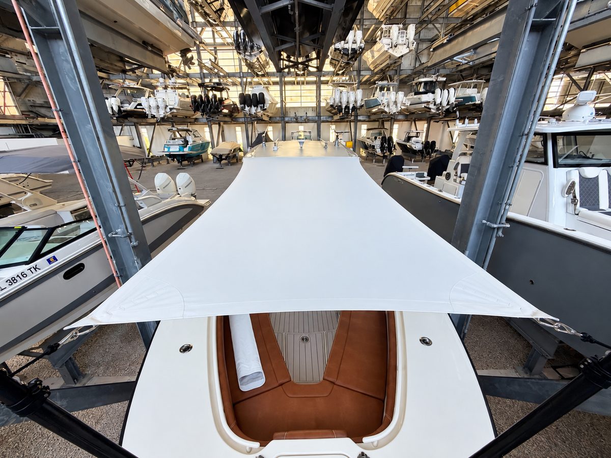 Overhead view of a custom bow sun shade on a 32-foot Scout center console, tensioned between two carbon fiber poles